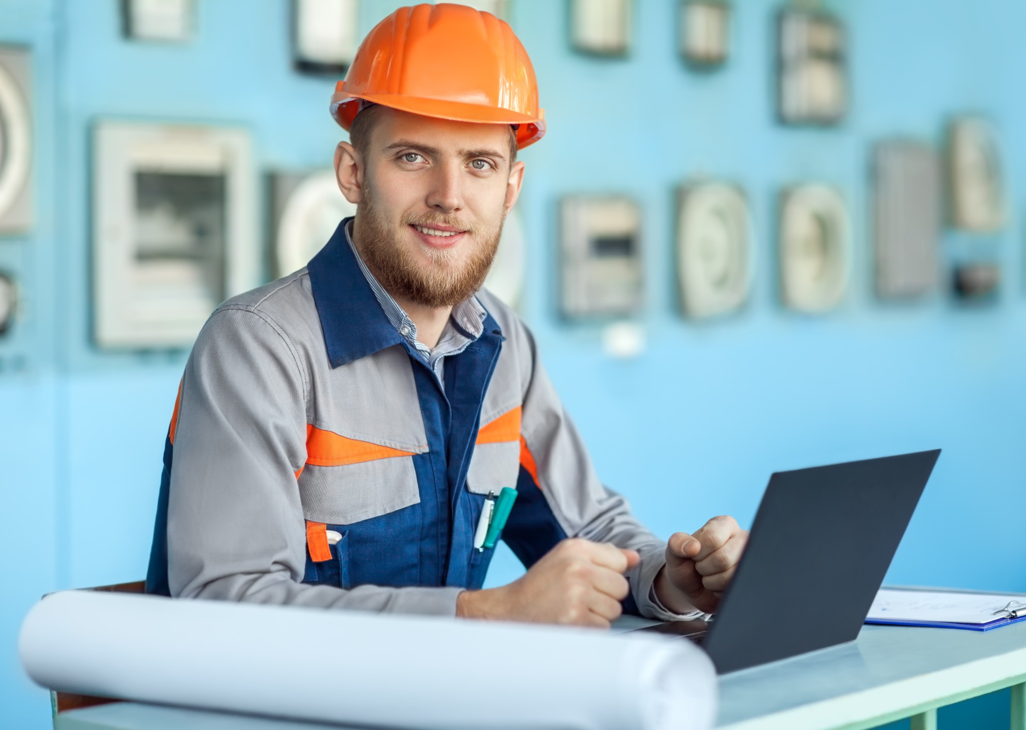Electrician reviewing plans on a laptop